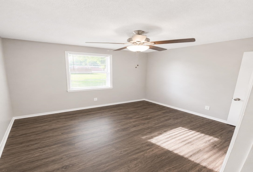 Room featuring wood-finish flooring and neutral wall tones
