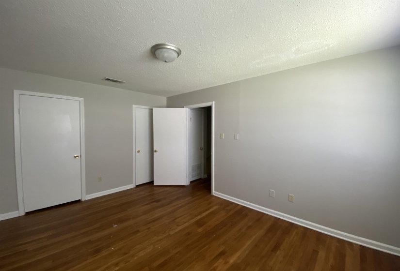 Wood-finish flooring complemented by light gray walls and white trim