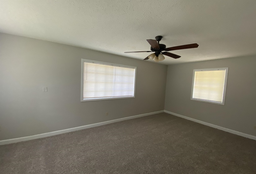 Spacious room featuring neutral carpeting and light gray walls