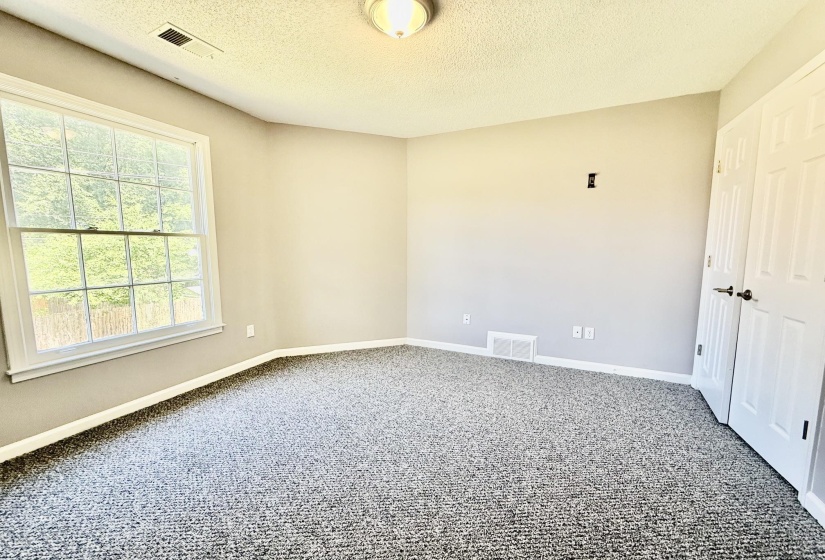 Carpeted room featuring a double-paned window, neutral wall paint, white trim, and a flush-mount ceiling light fixture