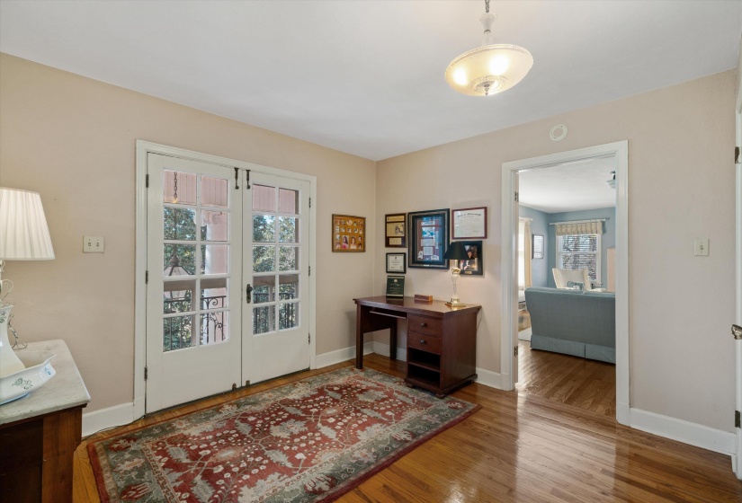 Entryway featuring hardwood flooring, a semi-flush mount ceiling light, and double French doors with transom windows