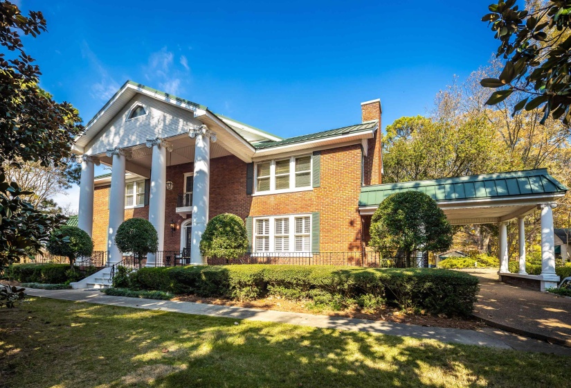 Brick exterior with a grand portico featuring four classical columns