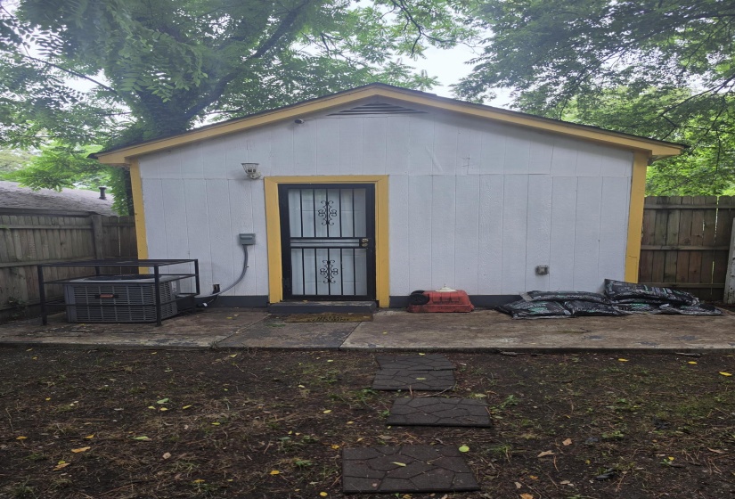 Detached structure featuring white siding and yellow trim