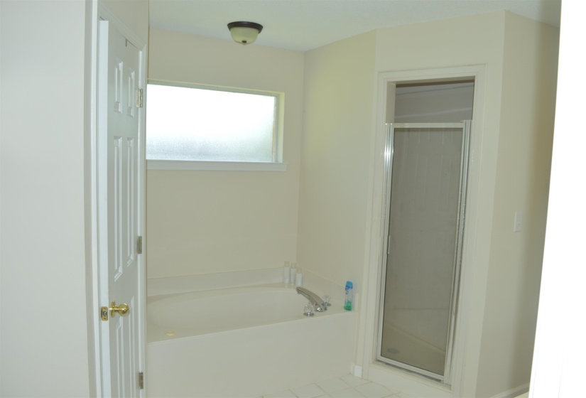 Master- Full bath with a bath, a shower stall, and tile patterned floors