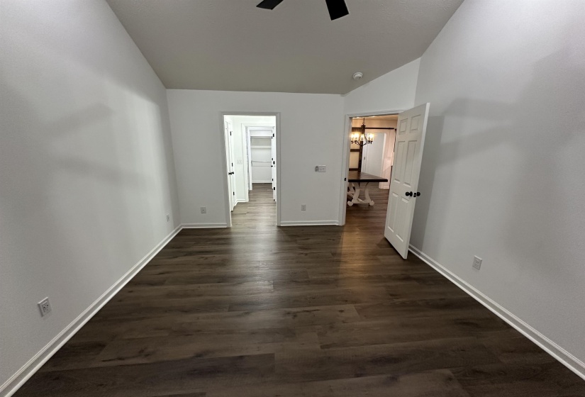 Primary bedroom with vaulted ceiling
