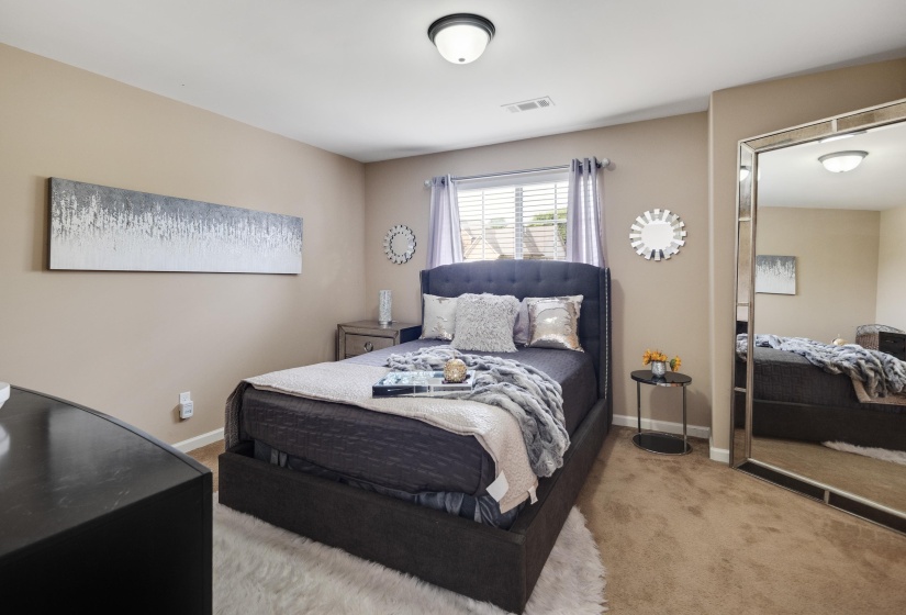 Carpeted room with a ceiling-mounted light fixture, window with blinds, and neutral-toned walls