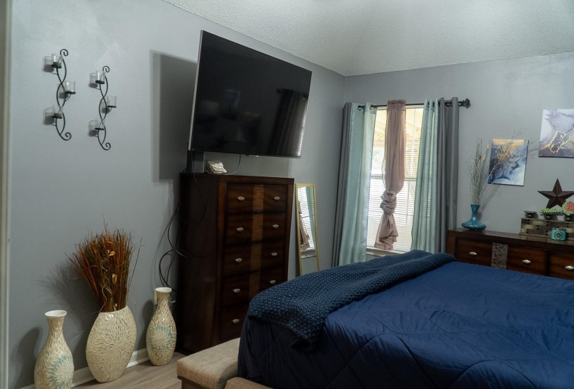 Bedroom featuring neutral gray walls and wood-finish flooring