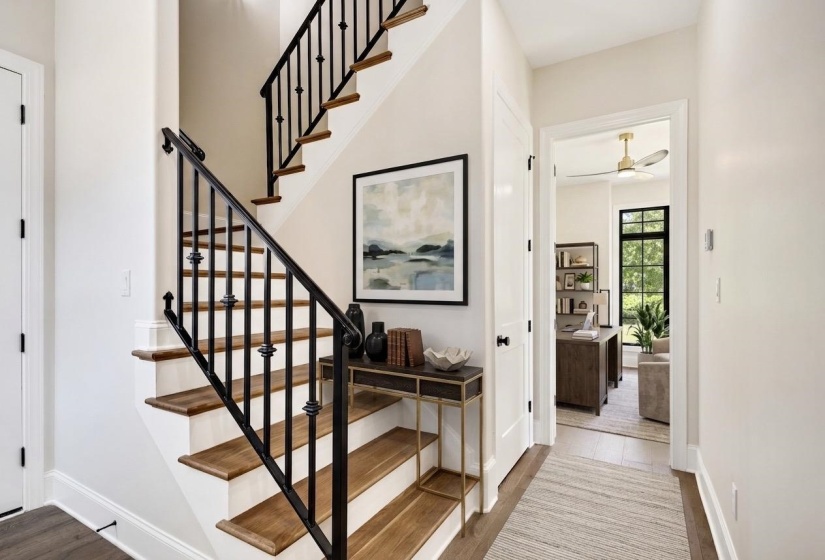Hardwood staircase with wrought iron balusters and wood-finish treads