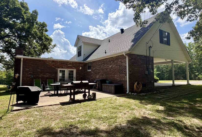 Brick exterior featuring a gabled roofline and attached carport