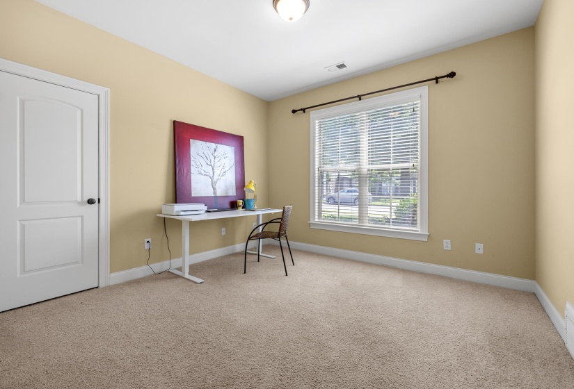 Carpeted room with a double-pane window featuring white blinds