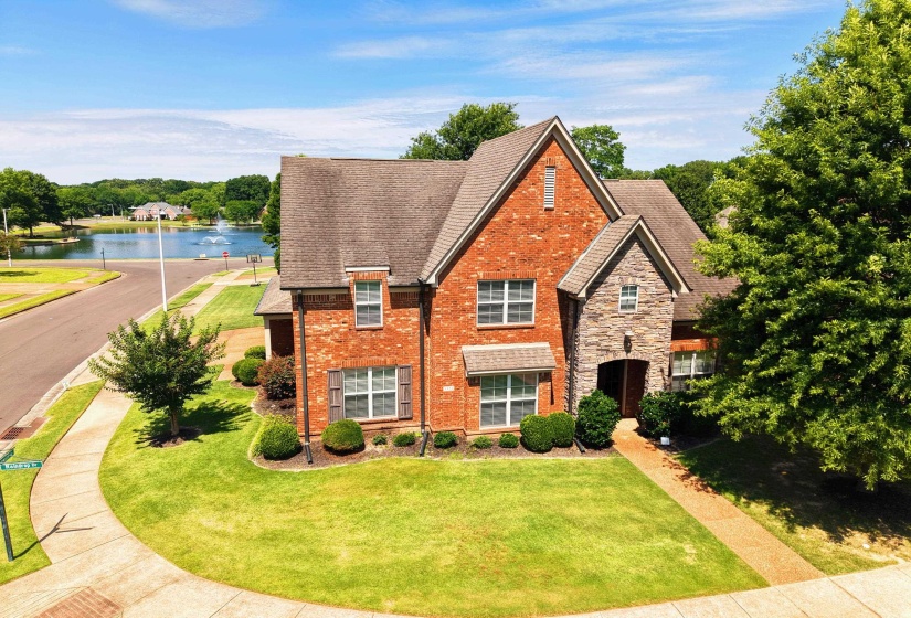 Traditional brick and stone facade residence featuring a prominent gabled roofline