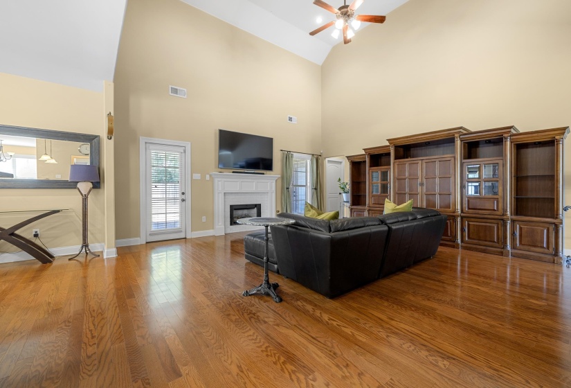 Vaulted ceiling living space with wood-finish flooring