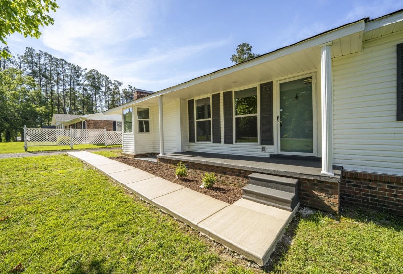 Single-story residence featuring white siding and a brick foundation