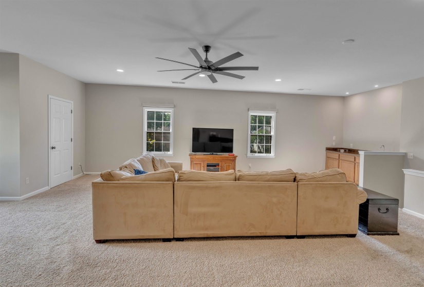Spacious room featuring neutral carpeting and light-colored walls