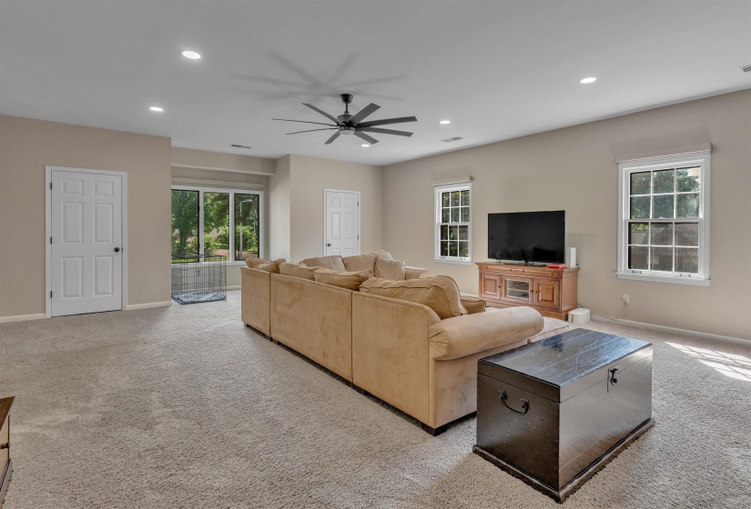 Spacious carpeted room featuring recessed lighting and a ceiling fan