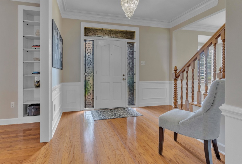 Entryway featuring wood-finish flooring and a decorative chandelier