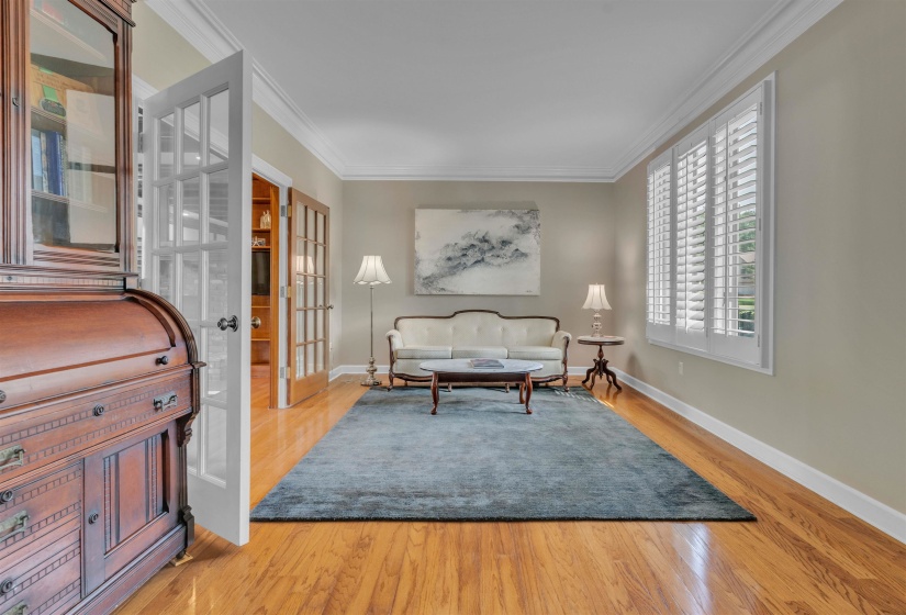 Hardwood flooring extending throughout, complemented by crown molding and neutral wall tones