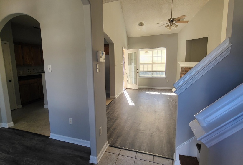 Hall featuring light hardwood / wood-style floors and high vaulted ceiling