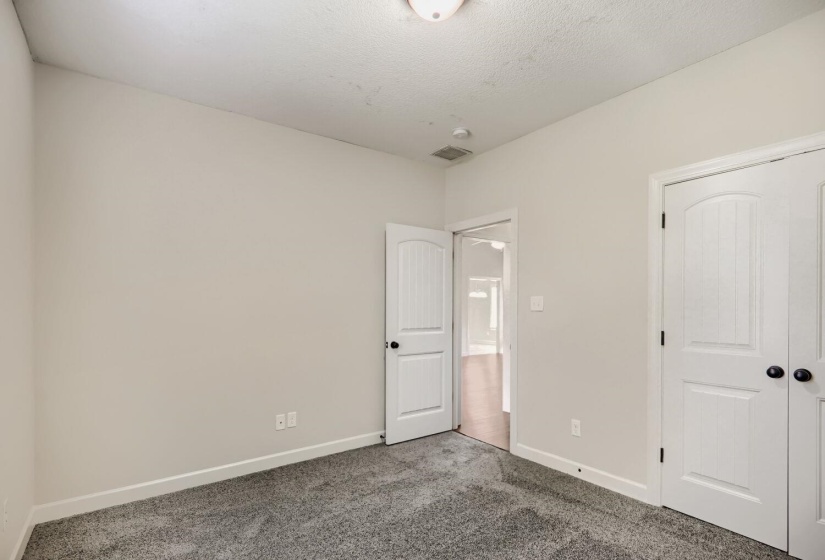 Room featuring light gray carpet, white baseboards, and neutral wall paint
