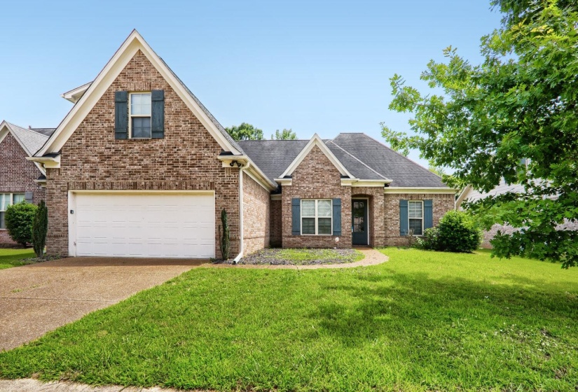 Brick exterior with a gabled roofline and dark shutters