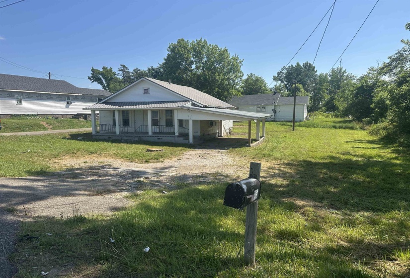 Single-story residence featuring a covered front porch and an attached carport