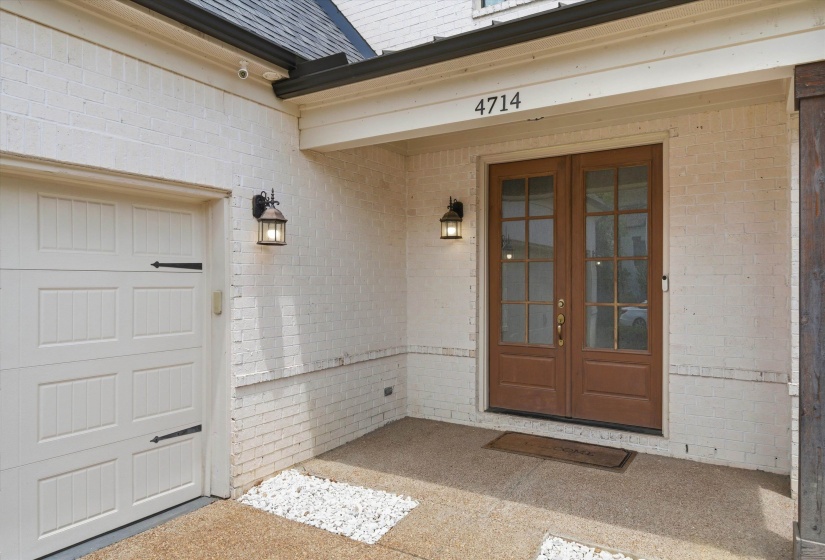 White painted brick exterior with a dark shingle roof