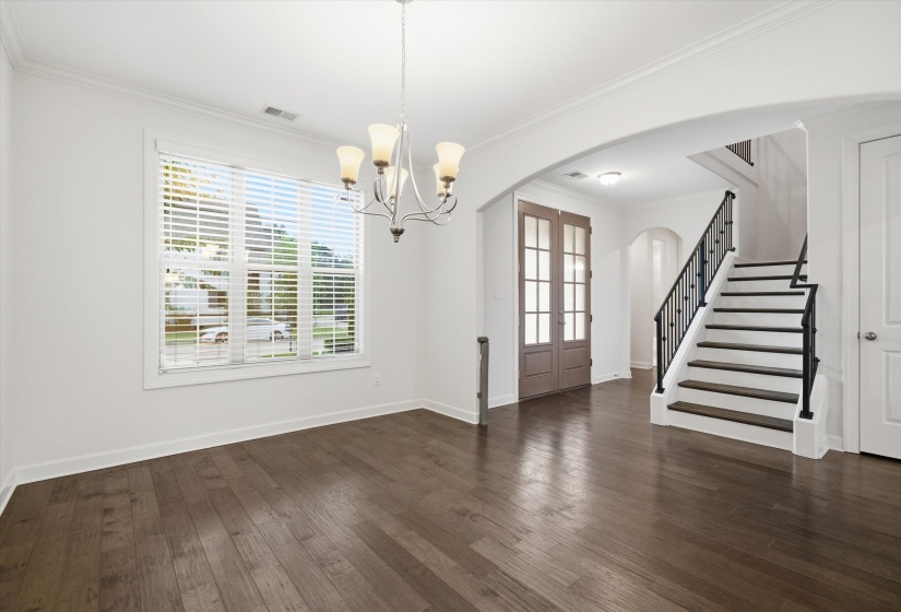 Formal dining area featuring wood-finish flooring and a contemporary chandelier