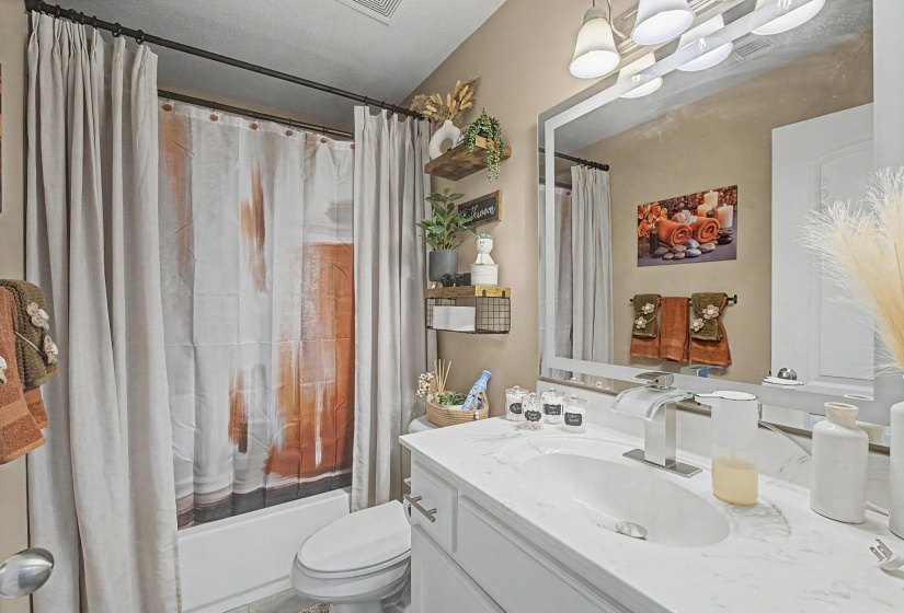 Bathroom featuring a large LED mirror