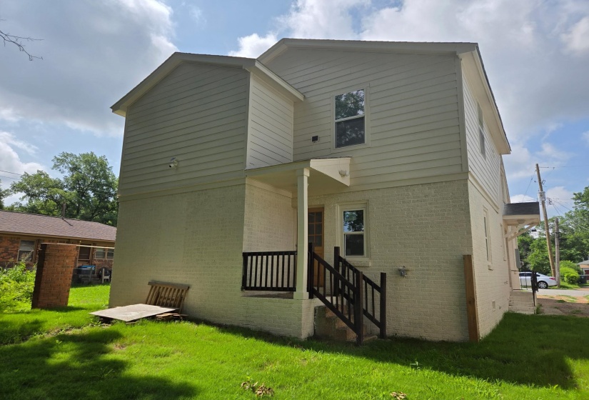 Contemporary multi-story exterior with light-colored siding and painted brick