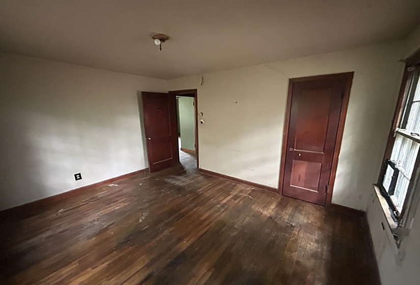Interior room featuring wood-finish flooring and two paneled doors