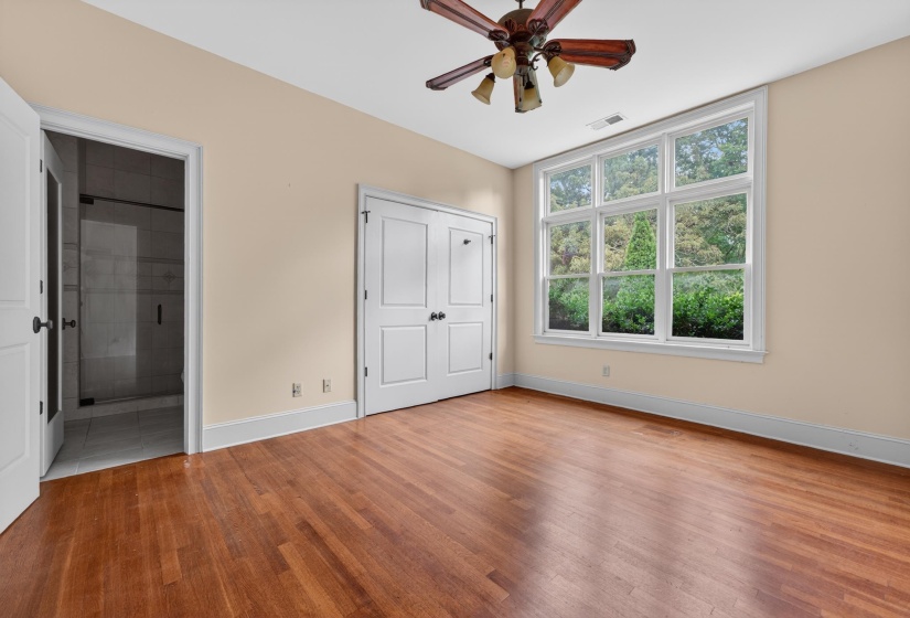 Warm wood flooring complements neutral wall tones