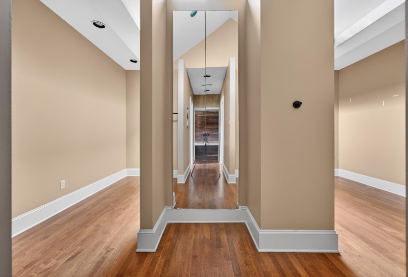 Hallway with wood-finish flooring and recessed lighting