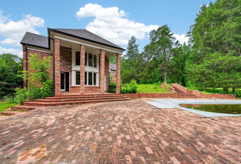 Brick exterior with a prominent two-story portico, supported by large columns