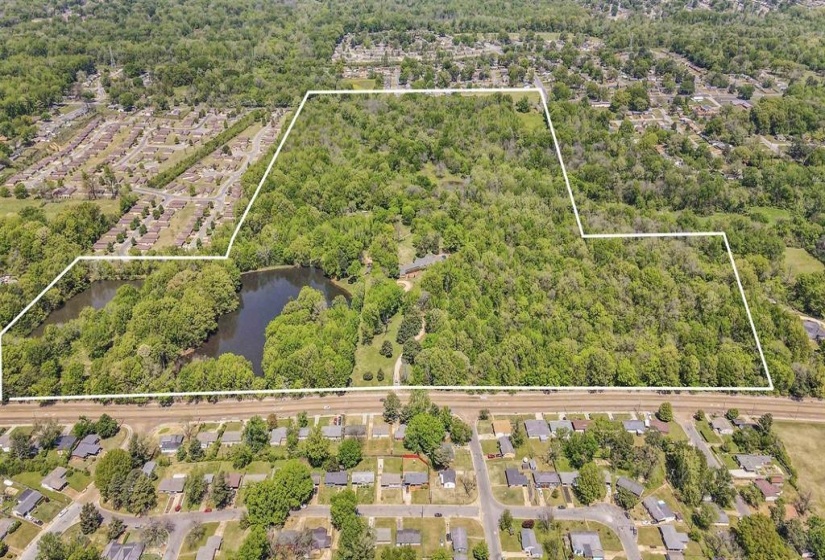 Expansive wooded acreage featuring a large private pond, mature tree canopy, and substantial undeveloped land