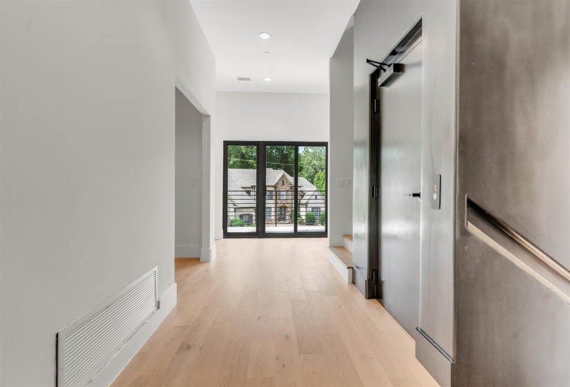 Corridor with light wood finished floors and recessed lighting