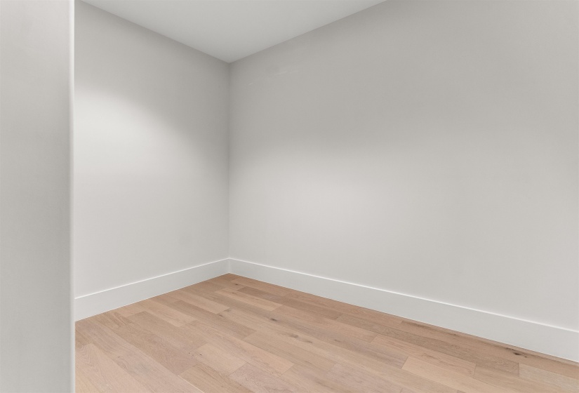Empty room featuring light wood finished floors and baseboards
