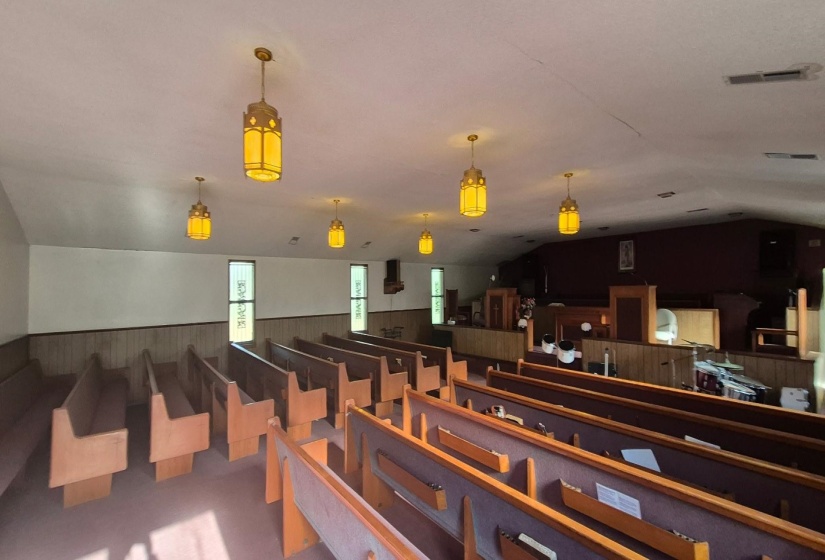 Miscellaneous room with wood walls, vaulted ceiling, and a wainscoted wall