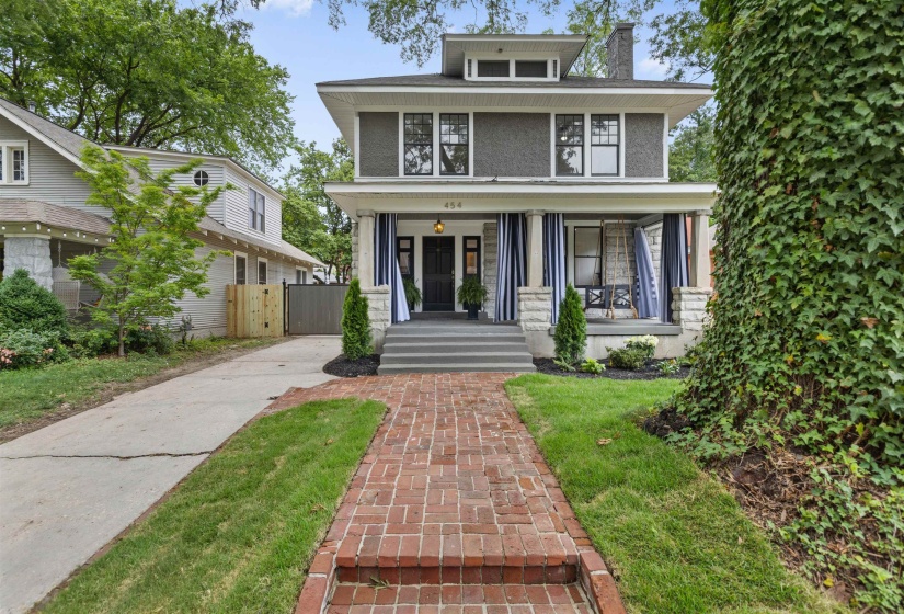 Craftsman-style facade featuring gray siding, white trim, and a prominent front porch