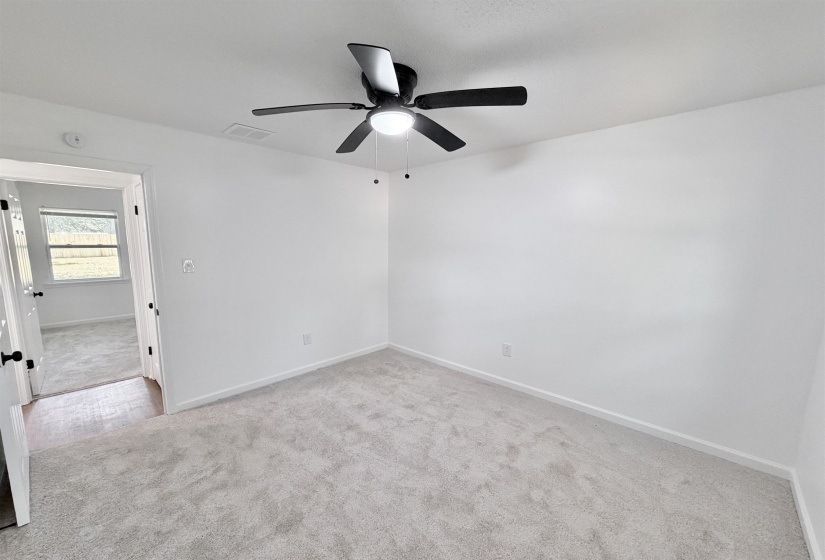 Neutral-toned carpeting paired with light-colored walls