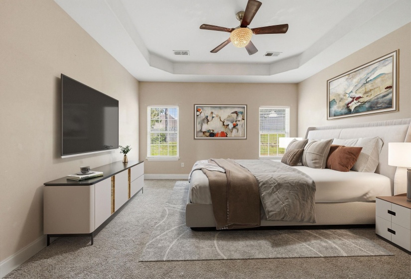 Recessed tray ceiling with crown molding, ceiling fan with integrated lighting, two windows with blinds, and neutral tone carpeting