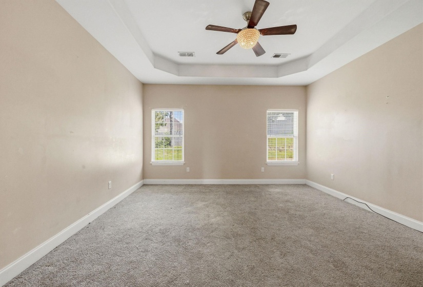 Spacious room featuring neutral carpeting and light wall tones