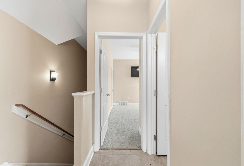 Interior hallway featuring warm neutral wall tones and white trim