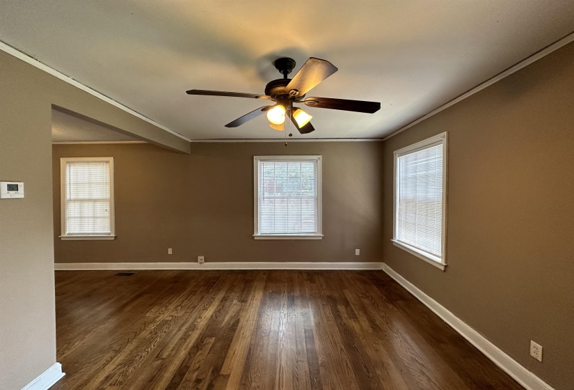 Hardwood flooring throughout, complemented by a ceiling fan with integrated lighting