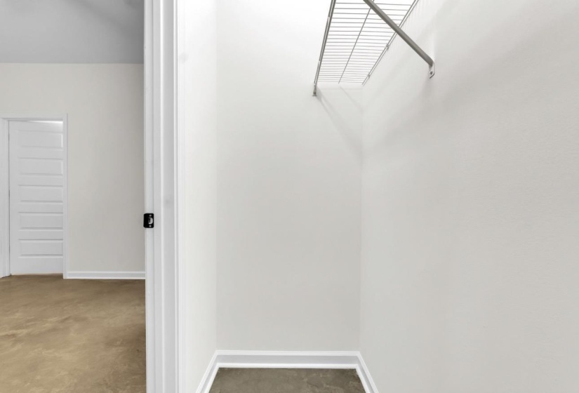Interior closet with wire shelving and hanging rod