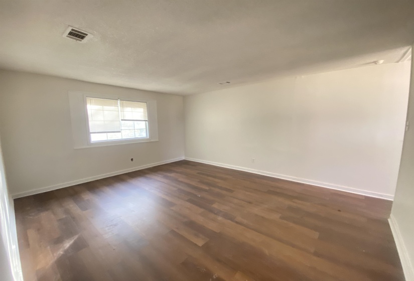 Unfurnished room with dark wood-style floors and baseboards