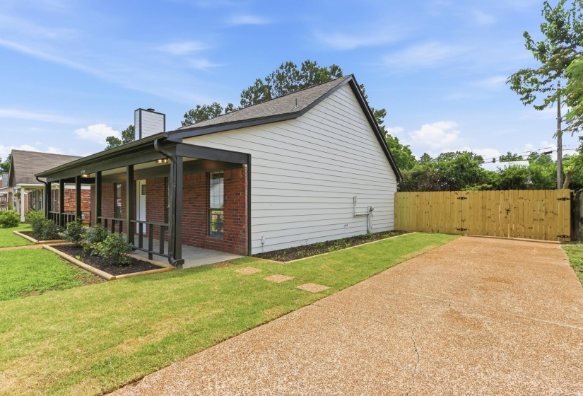 Brick and siding exterior featuring a covered front porch with dark-stained posts and railings