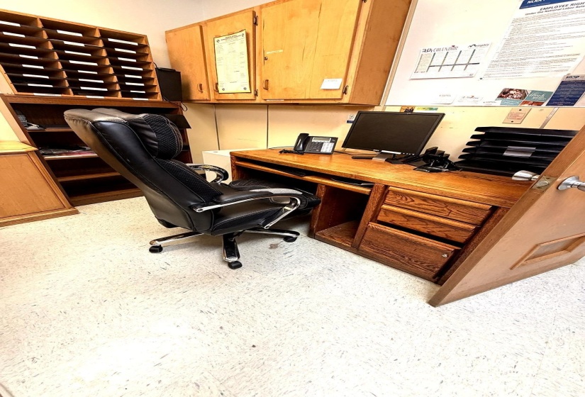 Office area with light flooring and built in study area