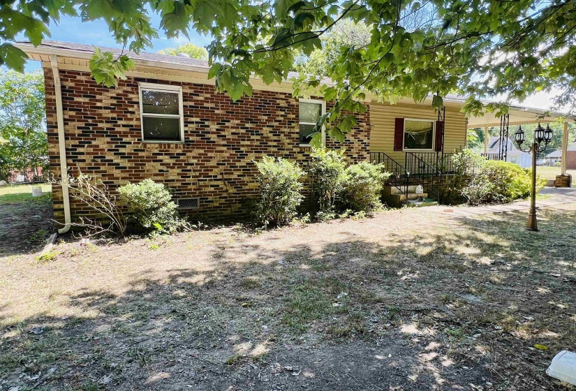 View of front of home featuring brick siding and crawl space