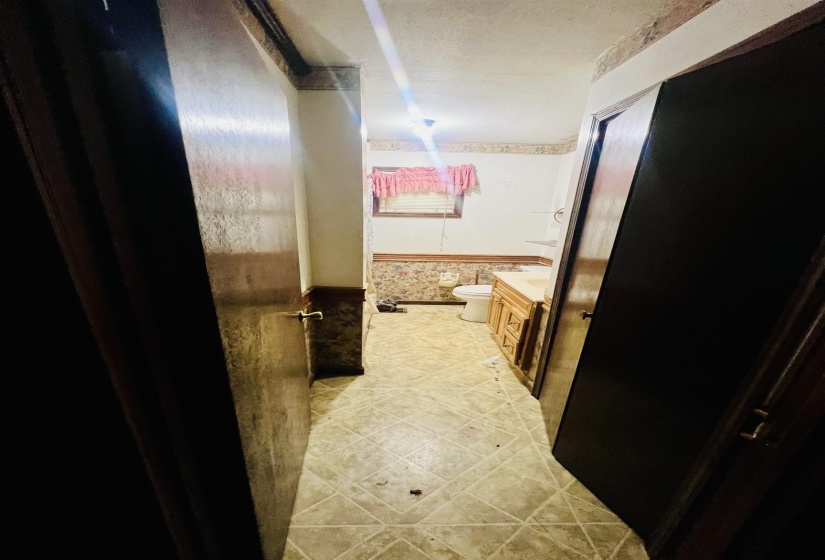 Bathroom with vanity and a wainscoted wall