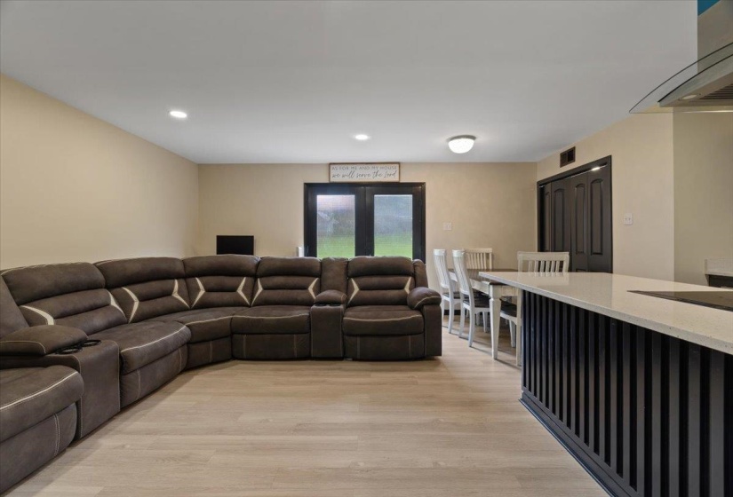 Open-concept living space with light wood-finish flooring